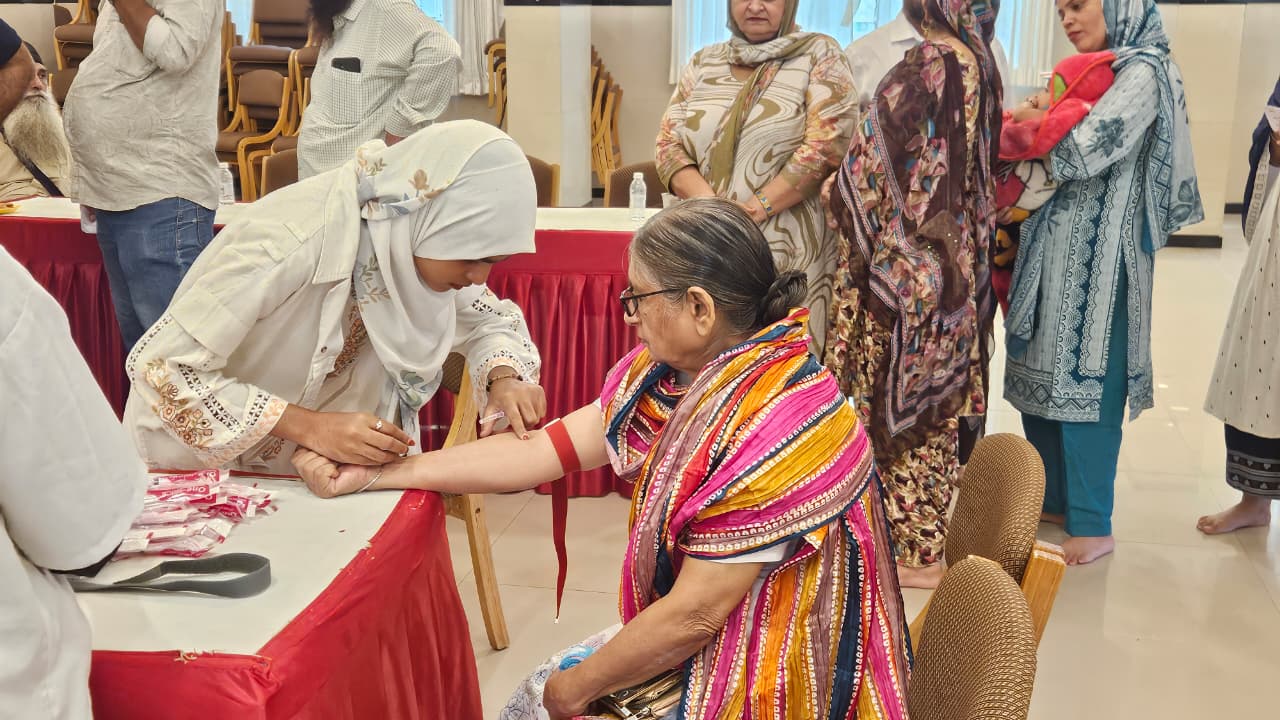 Blood sample being collected from an attendee at the Health Checkup Camp in Vapi with blood testing